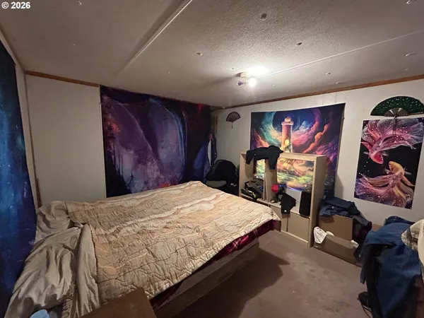 a bedroom with a bed and glass wall