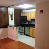a kitchen with a refrigerator and a stove