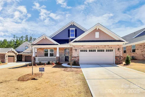 a large kitchen with stainless steel appliances granite countertop a large counter top and a stove top oven