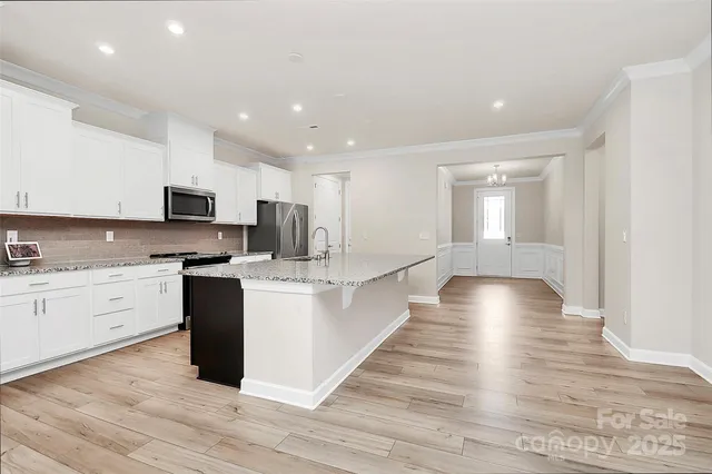 a kitchen with granite countertop a stove and a sink