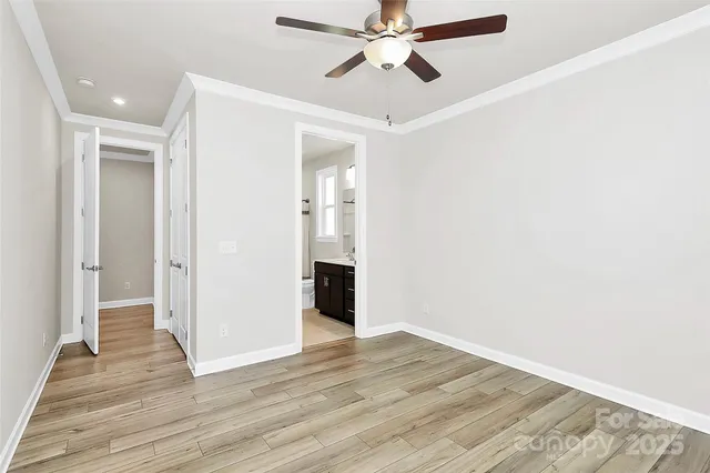 an empty room with a window and wooden floor