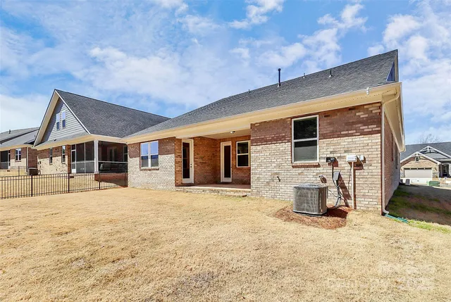 a front view of a house with a yard and seating space