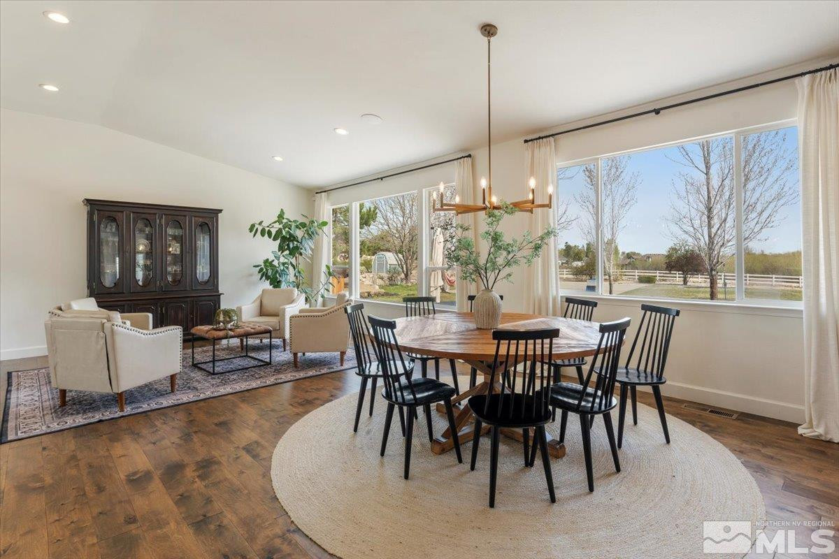 615 Flanders Road Reno, NV 89511 - Photo 8 of 39 a dining room with furniture a chandelier and wooden floor