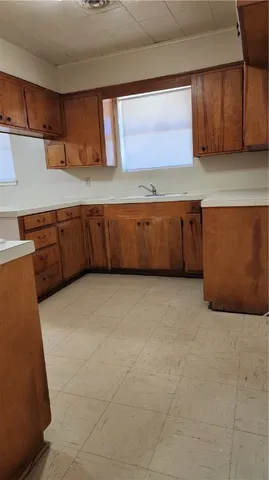 a kitchen with cabinets and a refrigerator