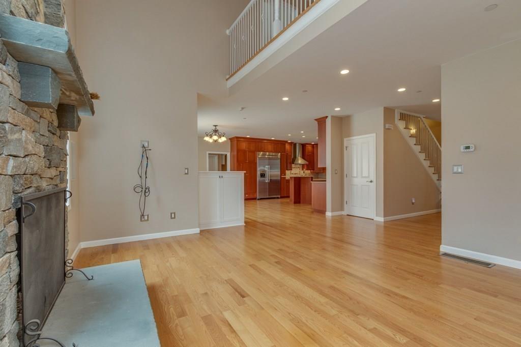 197 Dow Road Hollis, NH 03049 - Photo 11 of 38 a view of empty room with wooden floor and a fireplace