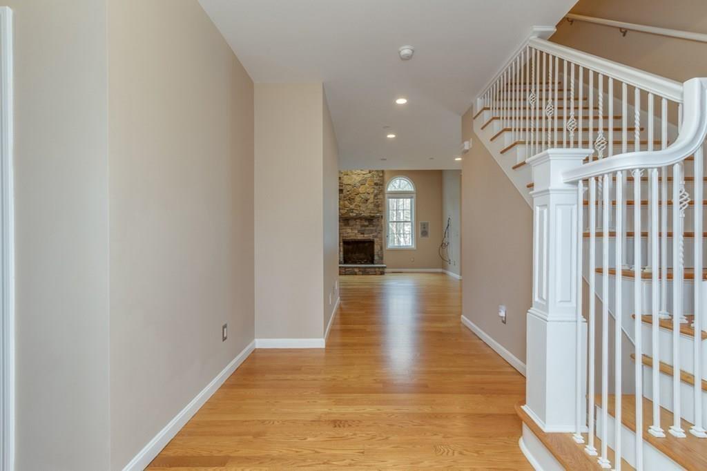 197 Dow Road Hollis, NH 03049 - Photo 12 of 38 a view of a hallway with wooden floor and staircase