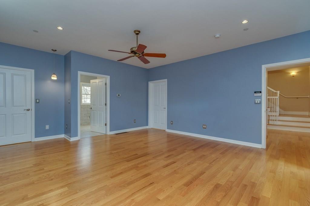 197 Dow Road Hollis, NH 03049 - Photo 13 of 38 a view of an empty room with wooden floor and fan