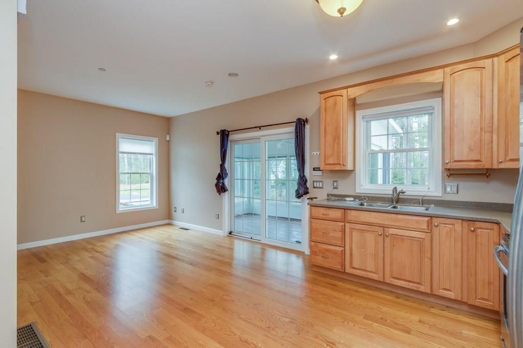 197 Dow Road Hollis, NH 03049 - Photo 25 of 38 a large kitchen with stainless steel appliances granite countertop a large window a sink and a granite counter tops