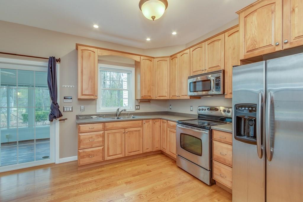 197 Dow Road Hollis, NH 03049 - Photo 28 of 38 a kitchen with stainless steel appliances granite countertop a stove a sink and a refrigerator