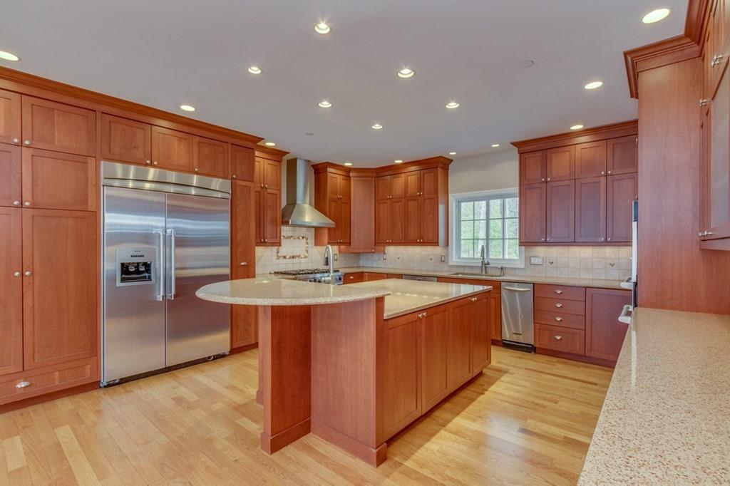 197 Dow Road Hollis, NH 03049 - Photo 3 of 38 a large kitchen with stainless steel appliances granite countertop a sink and a stove