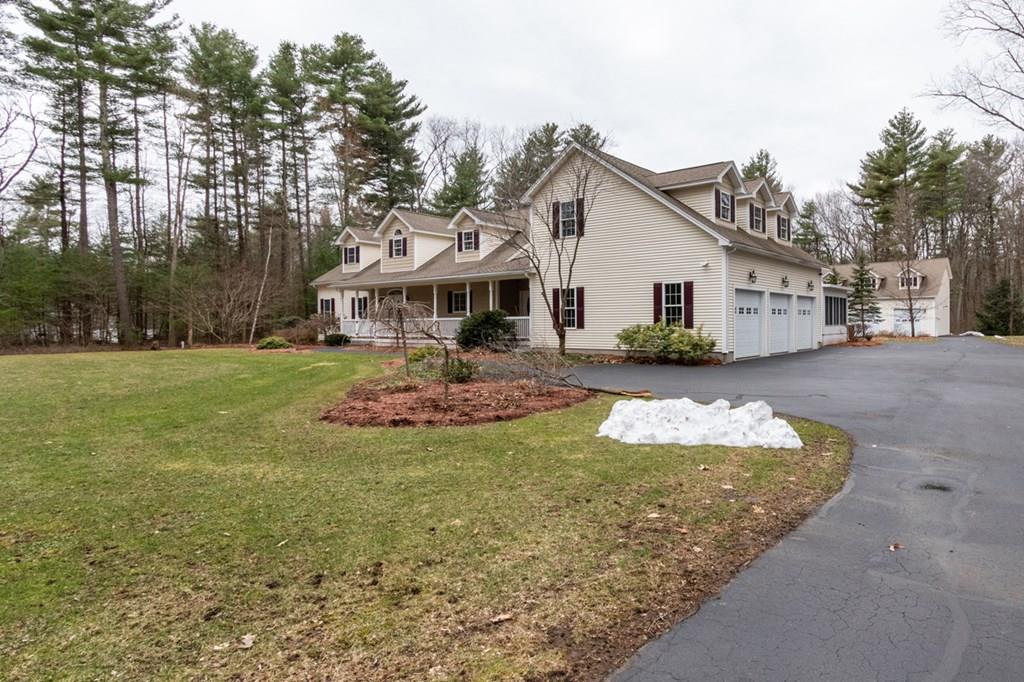 197 Dow Road Hollis, NH 03049 - Photo 34 of 38 a front view of a house with a yard outdoor seating and covered with trees