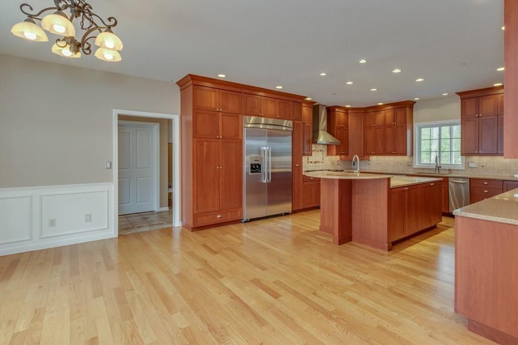 197 Dow Road Hollis, NH 03049 - Photo 5 of 38 a open kitchen with stainless steel appliances granite countertop a granite counter tops and a wooden floors