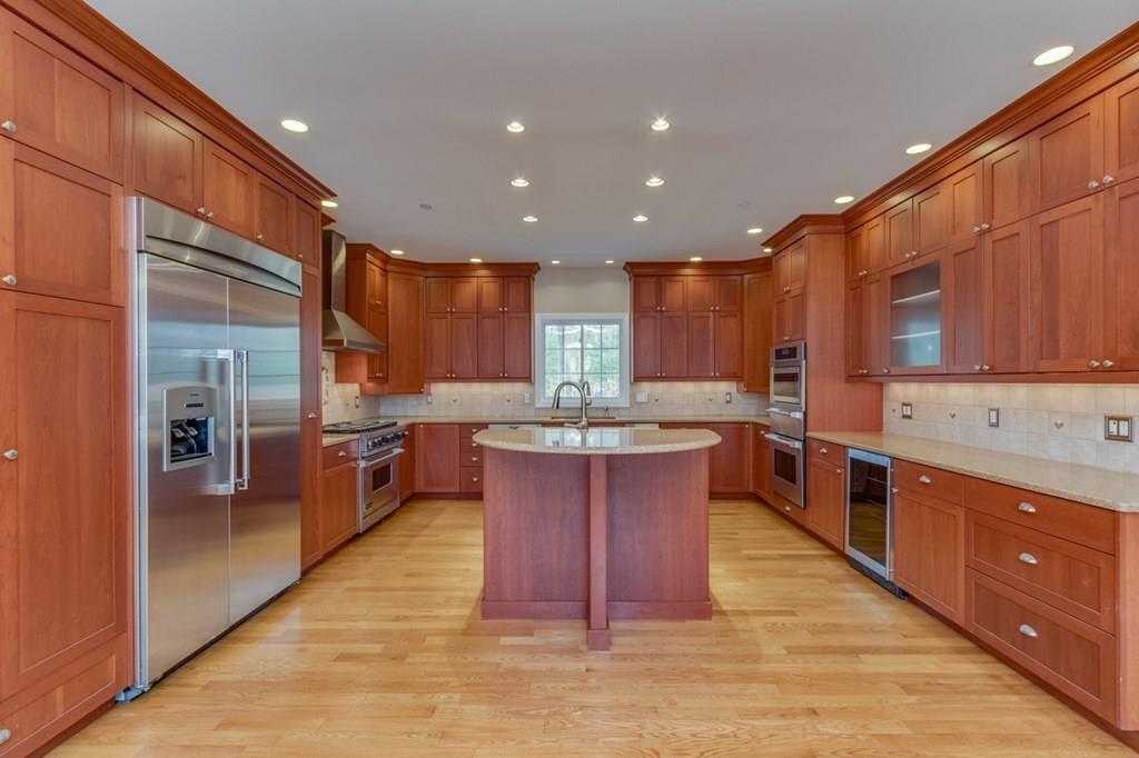 197 Dow Road Hollis, NH 03049 - Photo 6 of 38 a kitchen with stainless steel appliances granite countertop a refrigerator a sink a stove and a wooden floors