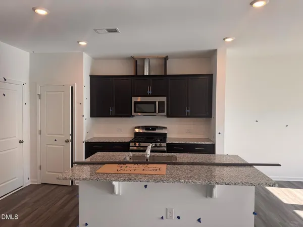 a kitchen with stainless steel appliances granite countertop a sink and a stove