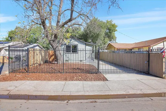 a view of a wrought iron fences in front of house