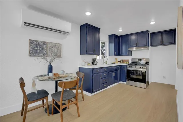 a kitchen with granite countertop wooden cabinets a sink and a stove