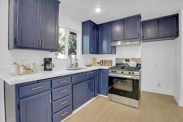 a kitchen with a sink and a stove