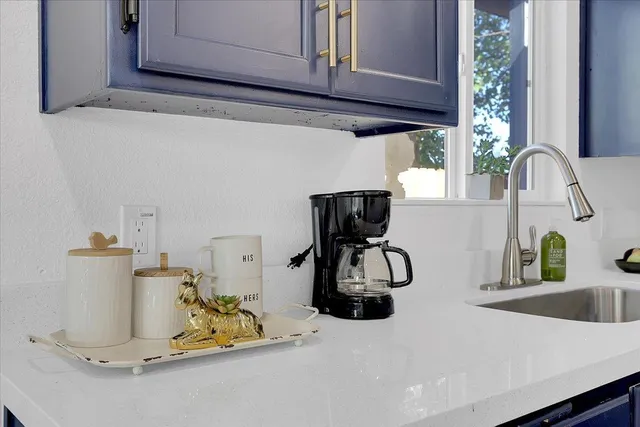 a kitchen with a stove a sink a dining table and chairs