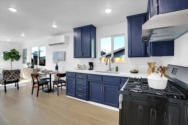a living room with furniture a wooden floor and a large window