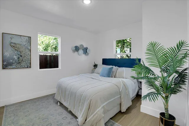a bedroom with a bed and a potted plant