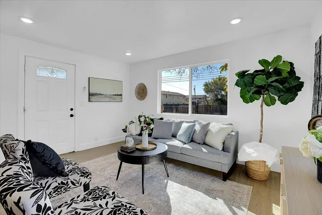 a living room with furniture and a large window
