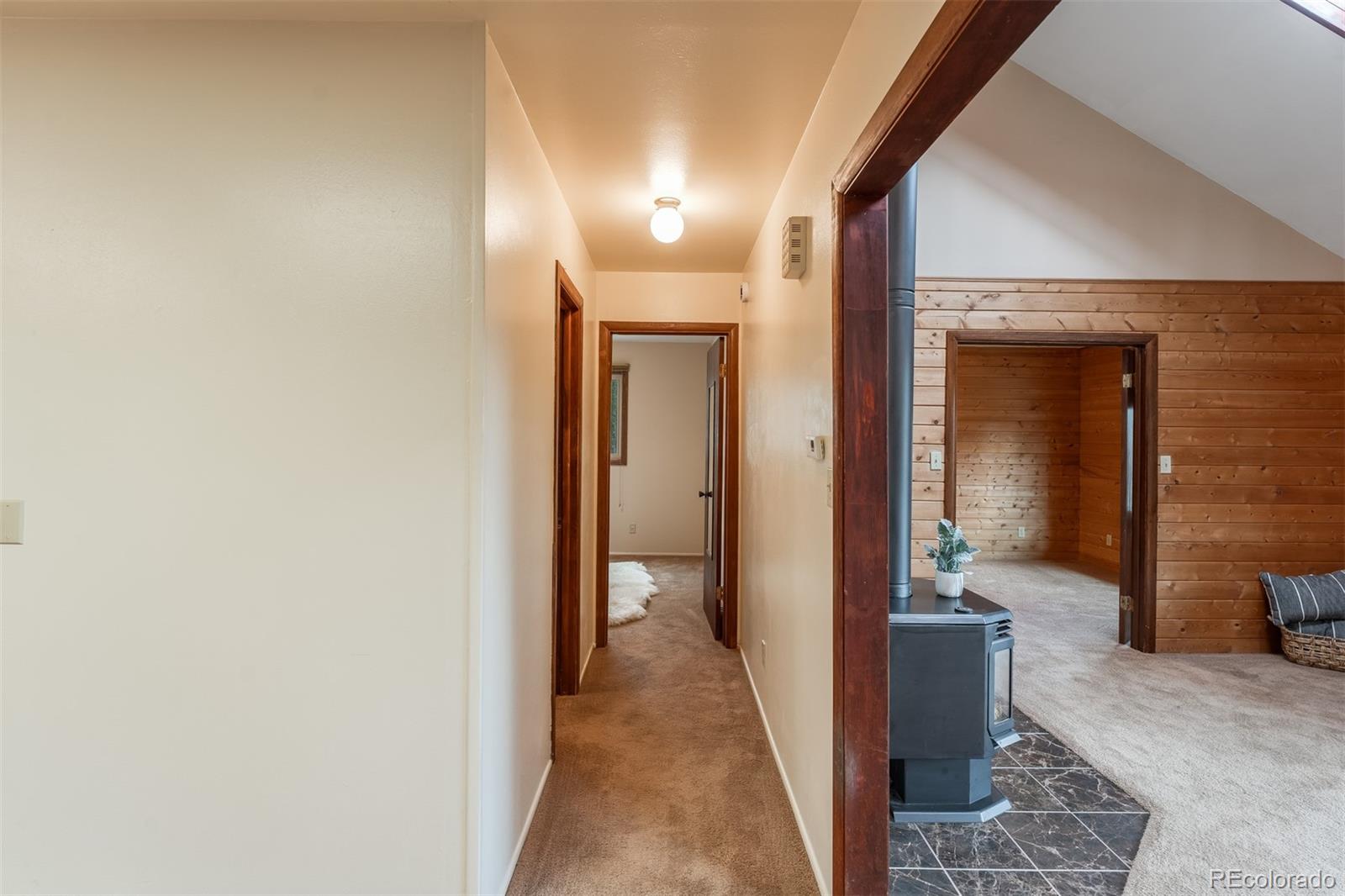 308 Rangeview Drive Black Hawk, CO 80422 - Photo 12 of 26 a view of a hallway with a livingroom and dining room with a couch