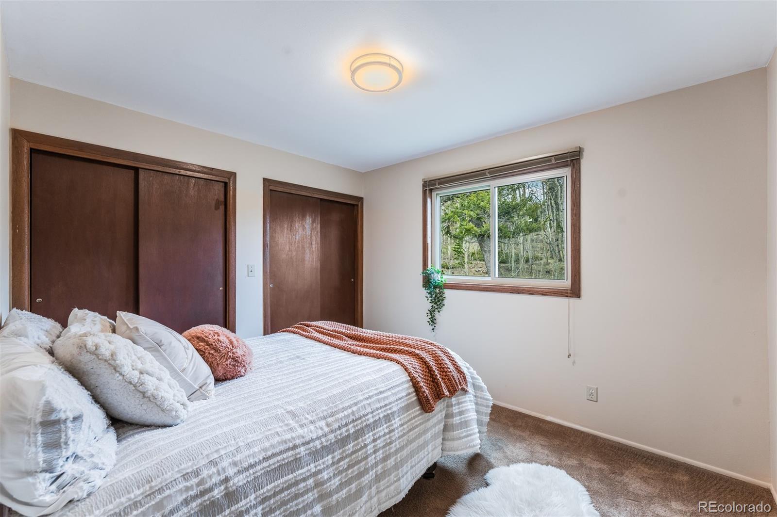 308 Rangeview Drive Black Hawk, CO 80422 - Photo 14 of 26 a bedroom with a bed and a window