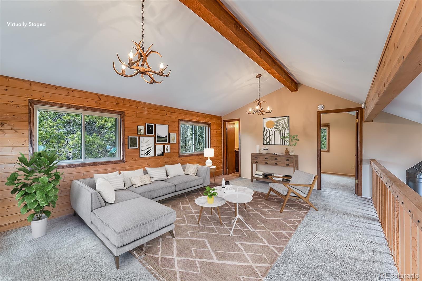 308 Rangeview Drive Black Hawk, CO 80422 - Photo 18 of 26 a living room with furniture a dining table and a large window