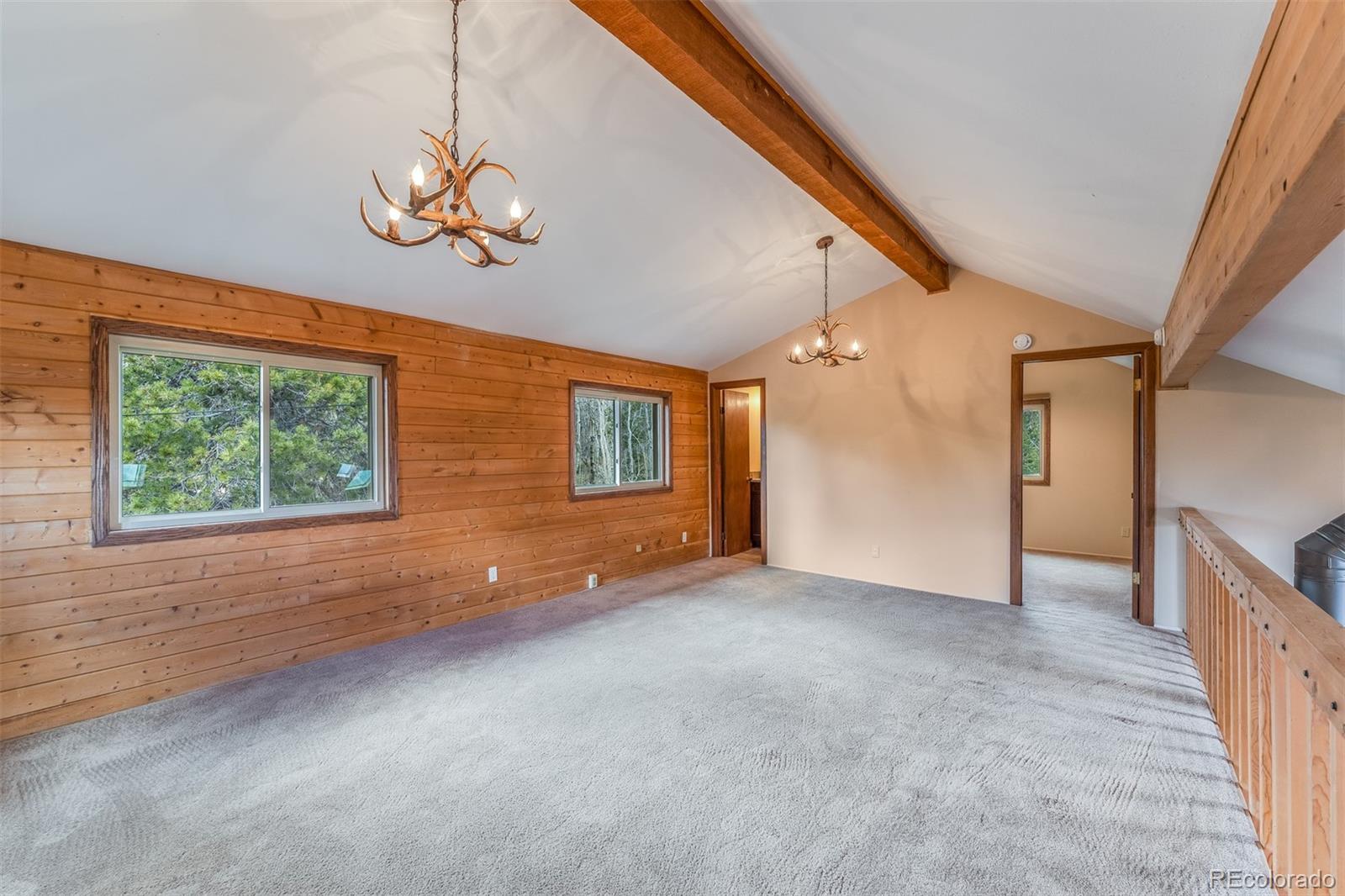 308 Rangeview Drive Black Hawk, CO 80422 - Photo 19 of 26 en empty room with windows and ceiling fan