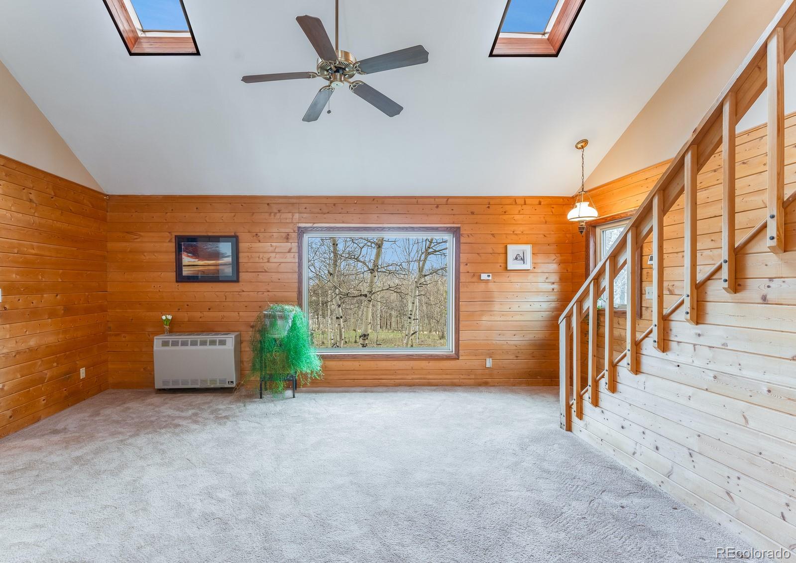 308 Rangeview Drive Black Hawk, CO 80422 - Photo 6 of 26 en empty room with stairs and windows