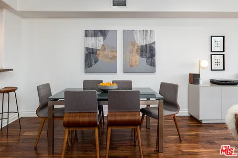 a view of a workspace with furniture and wooden floor
