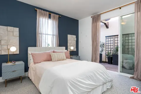 a bedroom with a bed and a lamp with window