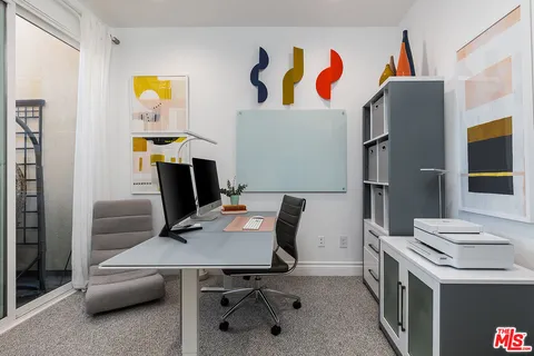 a workspace with furniture and window