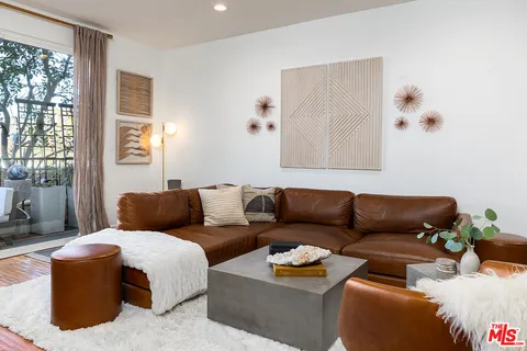 a living room with furniture couches and a large window