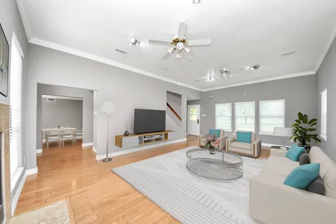 a large white kitchen with a sink and dishwasher a stove top oven with white cabinets