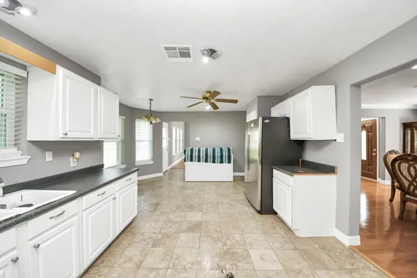 a kitchen with stainless steel appliances granite countertop a refrigerator and a sink