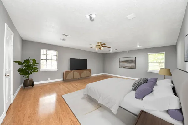a kitchen with a refrigerator and white cabinets