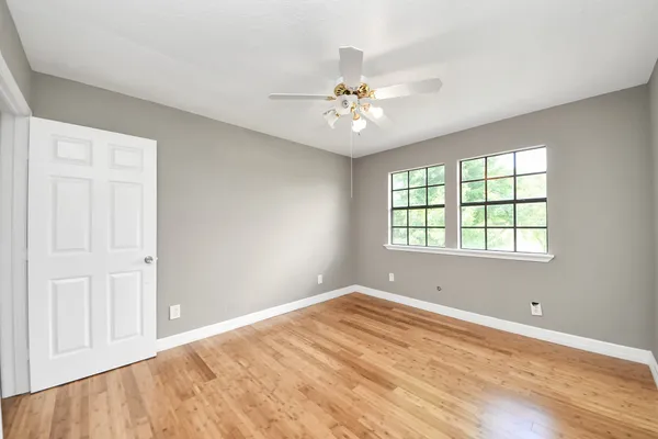 a spacious bathroom with a double vanity sink mirror and bathtub