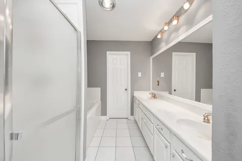 a bathroom with a bathtub and a shower