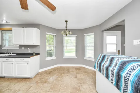 a front view of house with yard and trees in the background