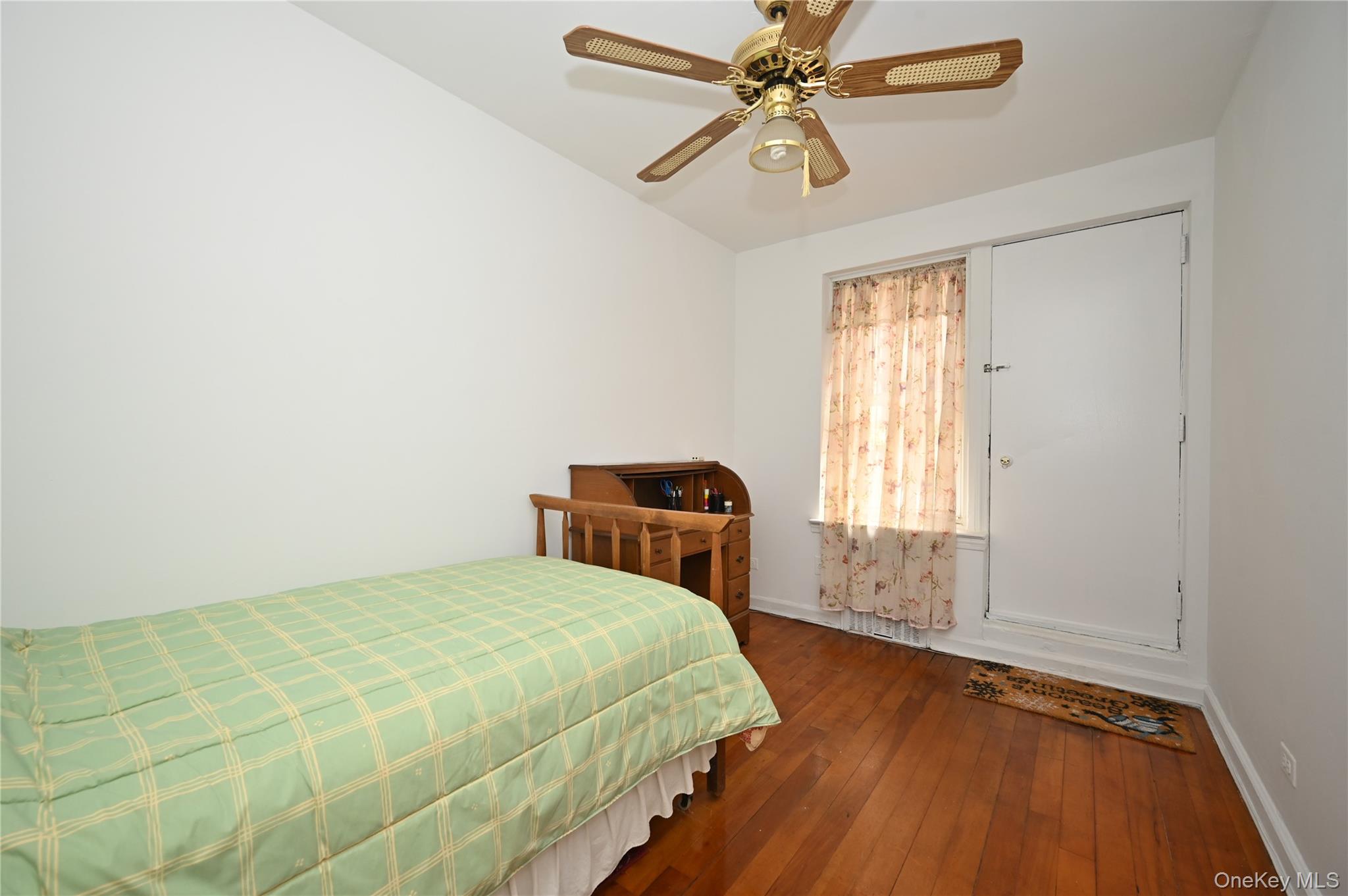 39-45 51st Street, Unit 1D Queens, NY 11377 - Photo 12 of 16 Bedroom featuring dark wood-style floors and ceiling fan