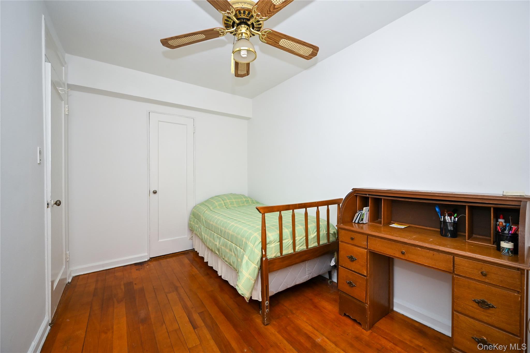39-45 51st Street, Unit 1D Queens, NY 11377 - Photo 13 of 16 Bedroom featuring dark wood-style floors, ceiling fan, and an office area