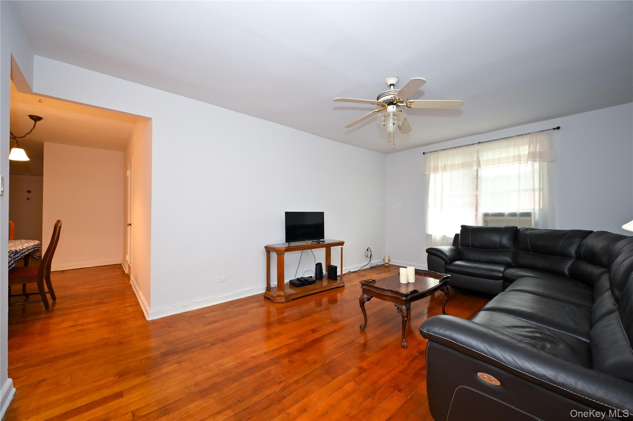 39-45 51st Street, Unit 1D Queens, NY 11377 - Photo 4 of 16 Living room featuring wood-type flooring and ceiling fan
