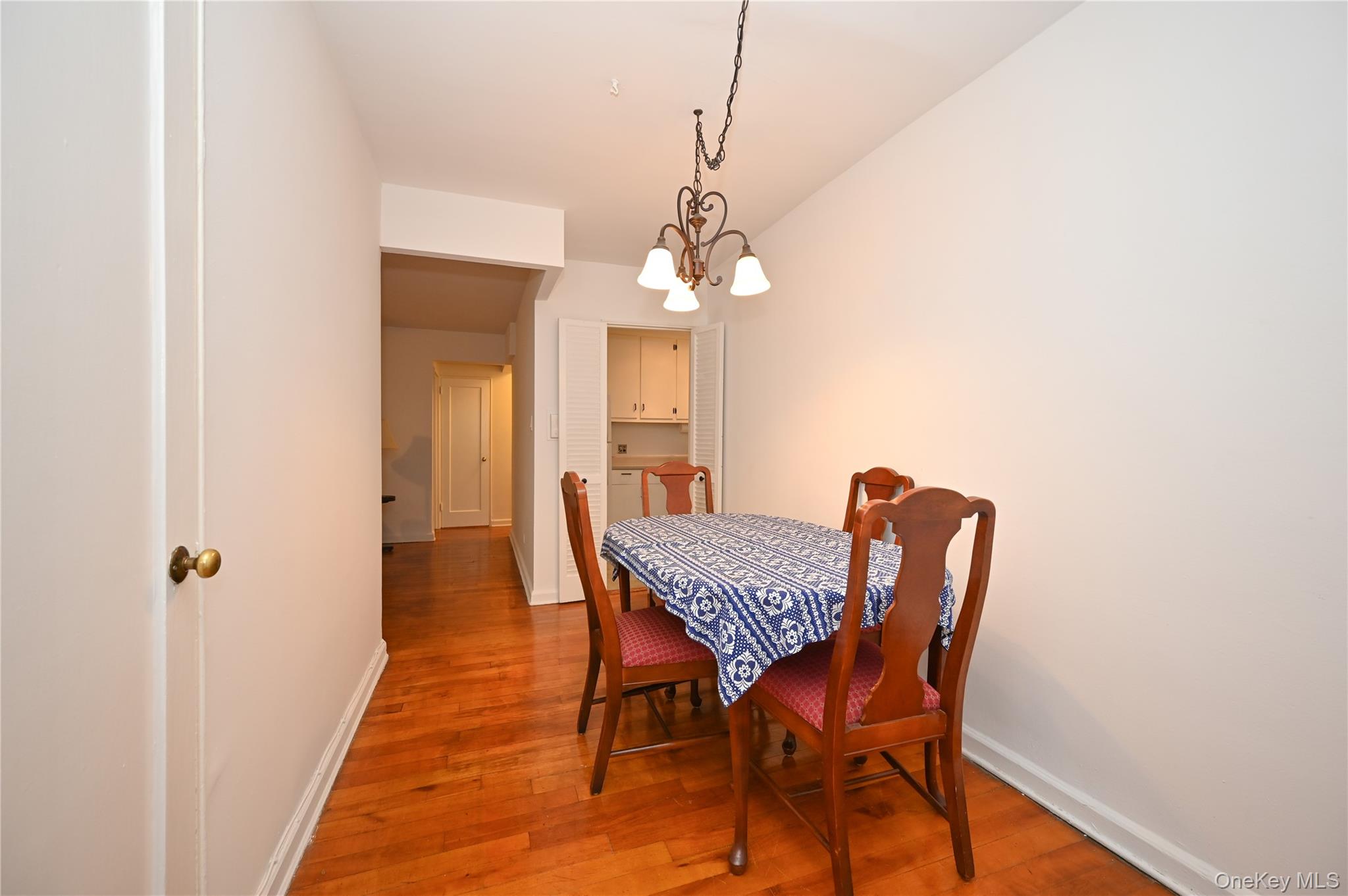 39-45 51st Street, Unit 1D Queens, NY 11377 - Photo 5 of 16 Dining area featuring light wood-style floors and a chandelier