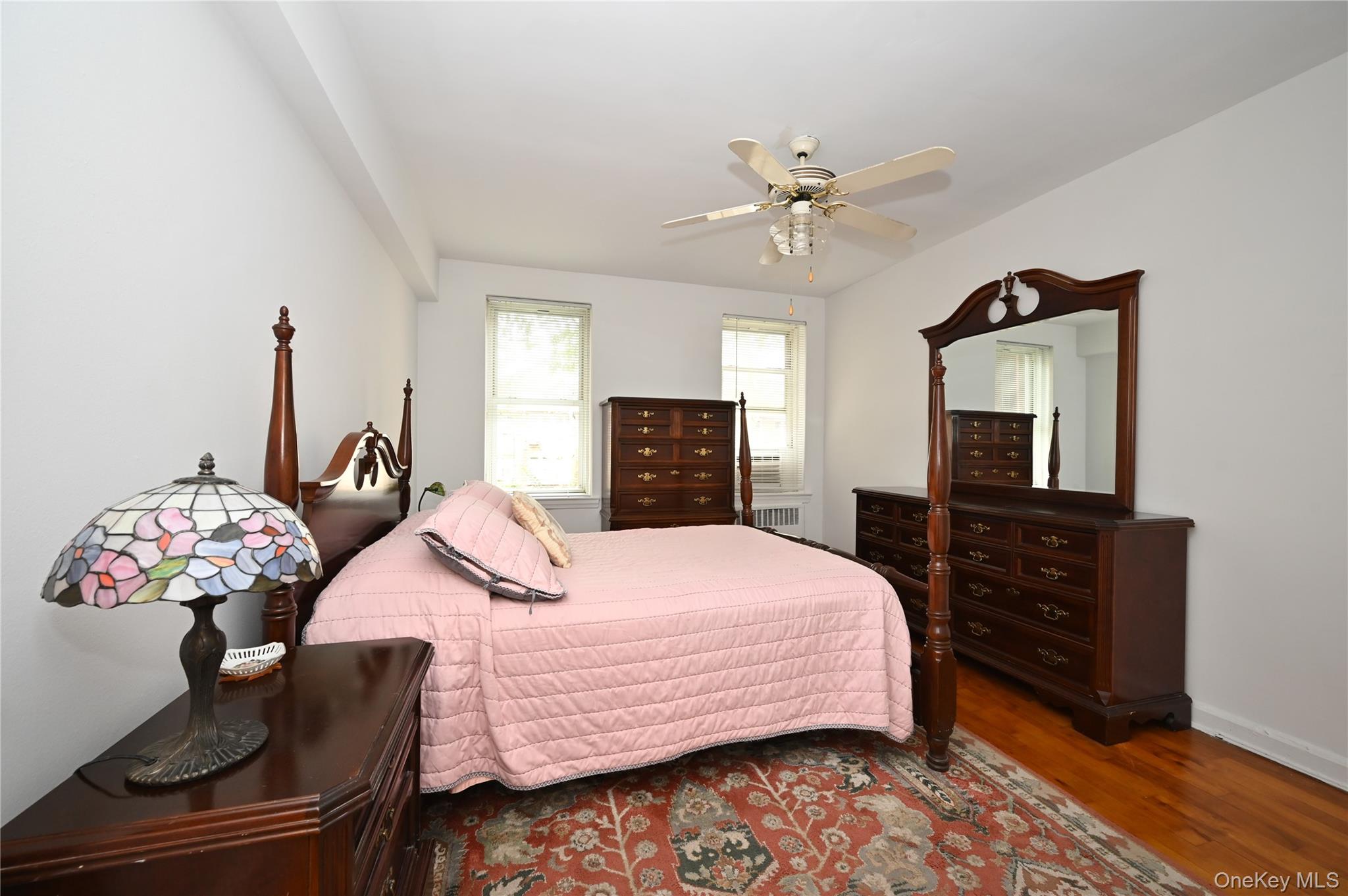 39-45 51st Street, Unit 1D Queens, NY 11377 - Photo 9 of 16 Bedroom featuring wood finished floors, a ceiling fan, and radiator heating unit