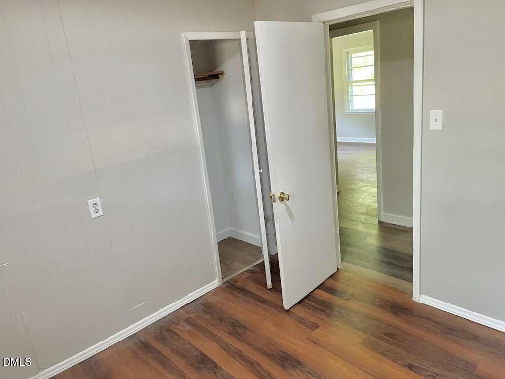 185 Summerhill Road Turkey, NC 28393 - Photo 10 of 18 an empty room with wooden floor and a window