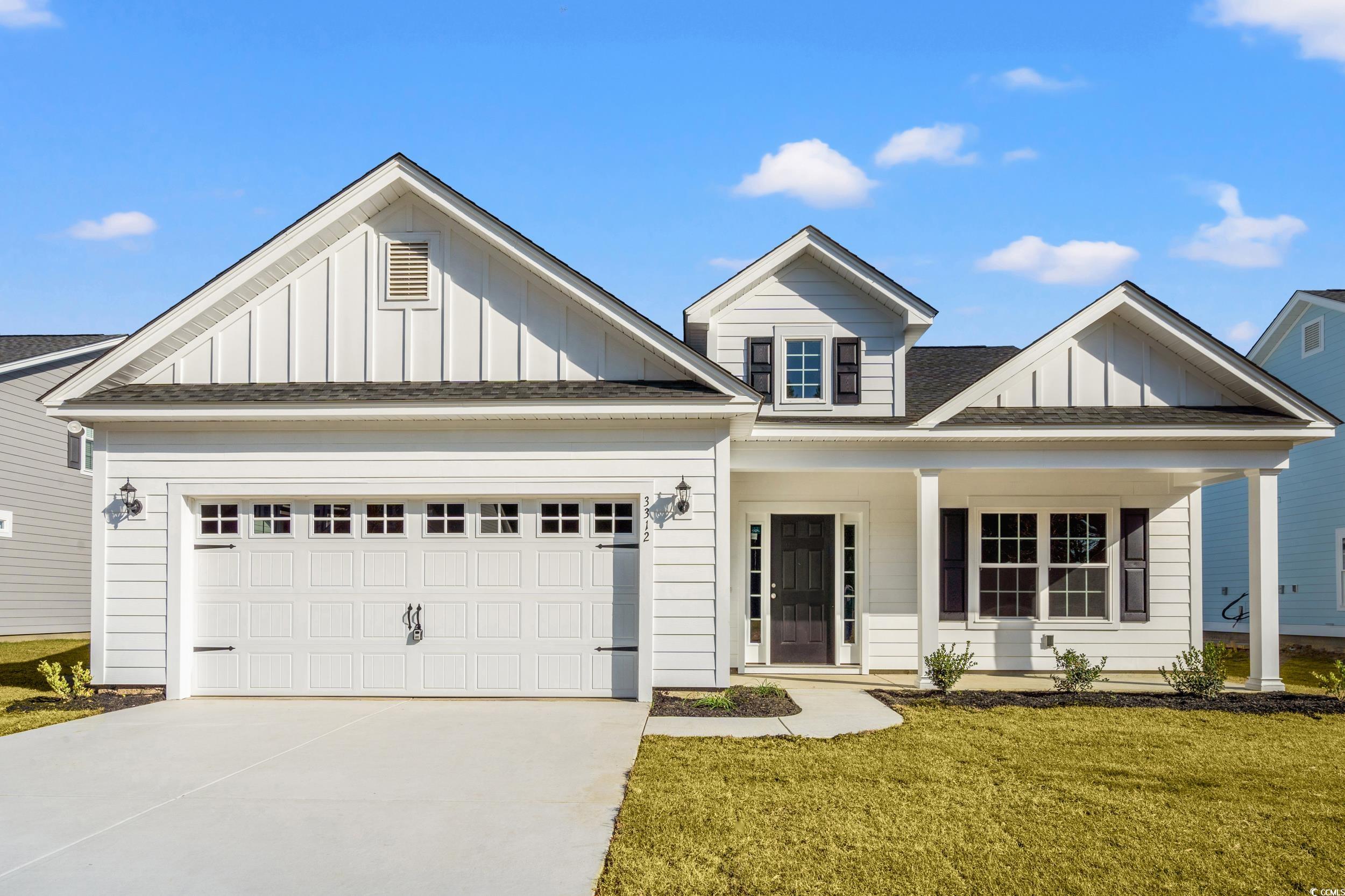 View of front of house featuring board and batten siding, a shingled roof, a porch, and a front yard