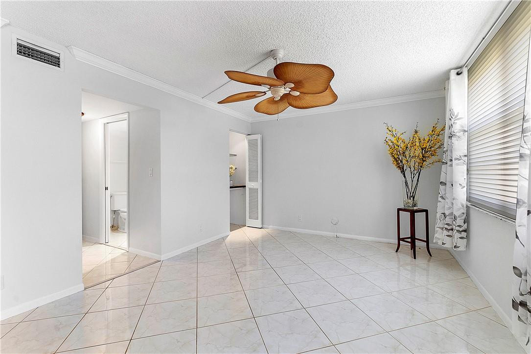 6100 Northwest 2nd Avenue, Unit 321 Boca Raton, FL 33487 - Photo 13 of 27 a view of an empty room with a window and a chandelier fan