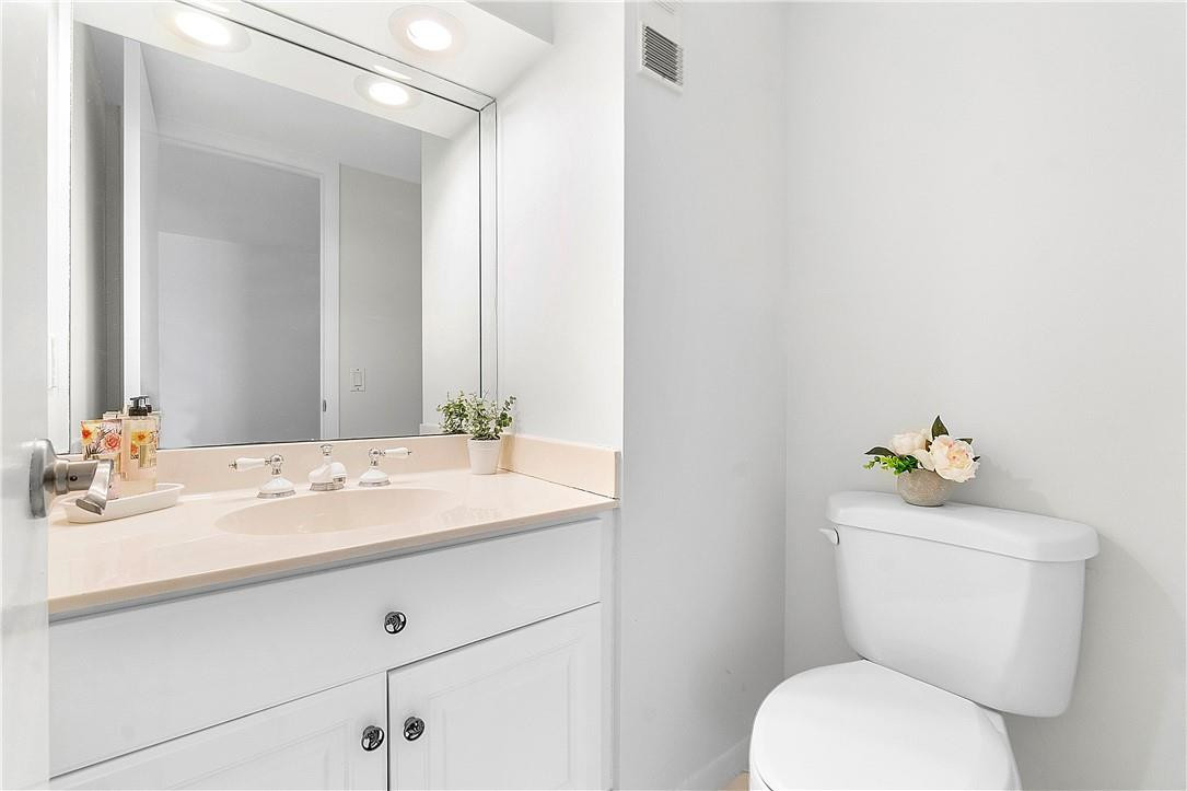 6100 Northwest 2nd Avenue, Unit 321 Boca Raton, FL 33487 - Photo 15 of 27 a bathroom with a sink mirror vanity and toilet