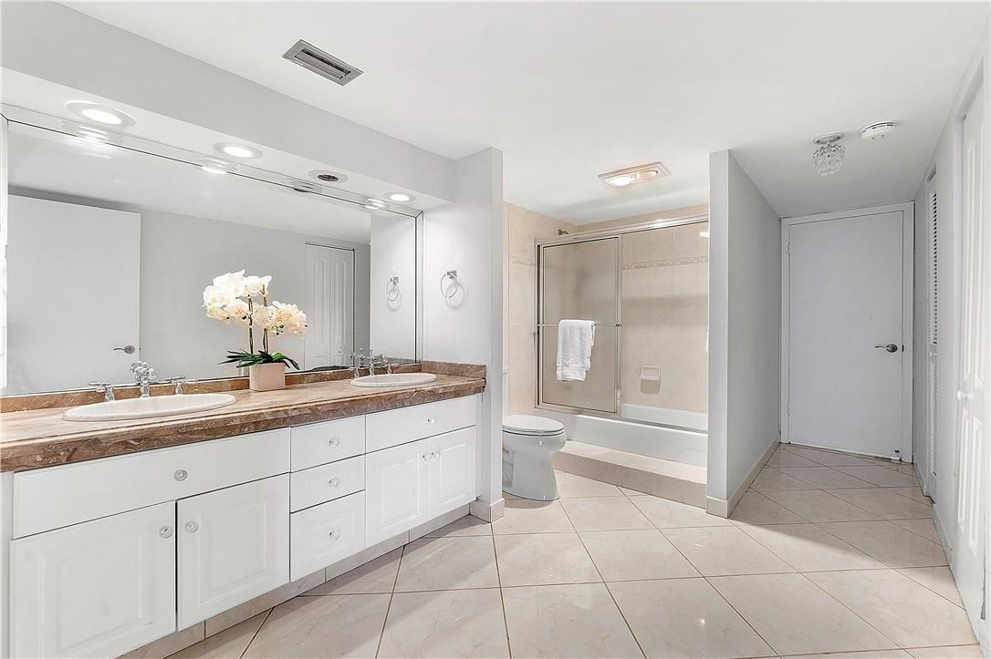 6100 Northwest 2nd Avenue, Unit 321 Boca Raton, FL 33487 - Photo 18 of 27 a spacious bathroom with a granite countertop sink a toilet a mirror and shower